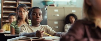 Movie still from “Swing Vote” (2008), directed by Joshua Michael Stern – A boy sitting at a table with a pencil; Close Up shot, Low angle