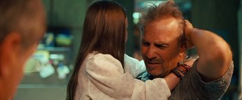 Movie still from “Swing Vote” (2008), directed by Joshua Michael Stern – A man and a little girl hugging each other; Close Up shot, Over the shoulder angle