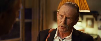 Movie still from “Swing Vote” (2008), directed by Joshua Michael Stern – An older man wearing a suit and tie; Close Up shot, Over the shoulder angle