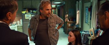 Movie still from “Swing Vote” (2008), directed by Joshua Michael Stern – A man standing next to a woman in a room; Medium shot, Over the shoulder angle