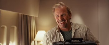 Movie still from “Swing Vote” (2008), directed by Joshua Michael Stern – A man smiling for the camera in front of a mirror; Close Up shot, Low angle