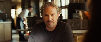 Movie still from “Swing Vote” (2008), directed by Joshua Michael Stern – A person wearing a black t - shirt; Close Up shot, Low angle