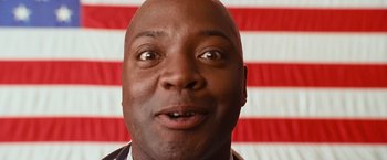 Movie still from “Swing Vote” (2008), directed by Joshua Michael Stern – A person with a flag in the background; Close Up shot, Low angle