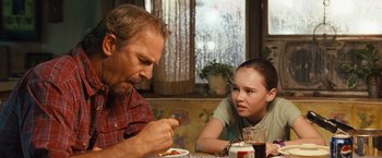 Movie still from “Swing Vote” (2008), directed by Joshua Michael Stern – A man and a girl sitting at a table eating food; Medium shot, Over the shoulder angle