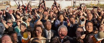 Movie still from “Swing Vote” (2008), directed by Joshua Michael Stern – A group of people taking pictures with cameras; Medium shot, High angle