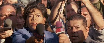 Movie still from “Swing Vote” (2008), directed by Joshua Michael Stern – A group of people holding microphones in front of a crowd; Close Up shot, High angle