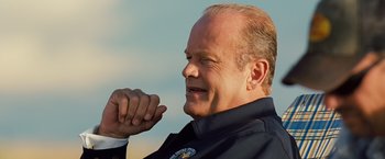 Movie still from “Swing Vote” (2008), directed by Joshua Michael Stern – A person wearing a suit and tie; Close Up shot, Low angle