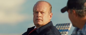 Movie still from “Swing Vote” (2008), directed by Joshua Michael Stern – A man with a beard and a jacket and tie; Close Up shot, Low angle