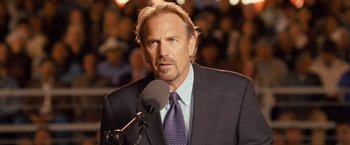 Movie still from “Swing Vote” (2008), directed by Joshua Michael Stern – A man in a suit and a microphone; Close Up shot, Low angle