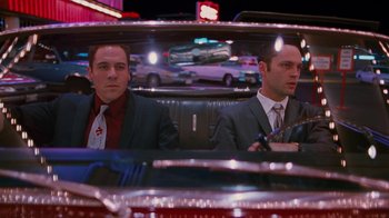 Movie still from “Swingers” (1996), directed by Doug Liman – A couple of men sitting in the back of a car; Medium shot, Low angle