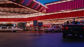 Movie still from “Swingers” (1996), directed by Doug Liman – Cars are parked in a parking lot at night; Extreme Wide shot, High angle