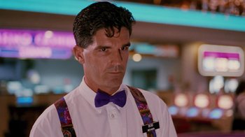Movie still from “Swingers” (1996), directed by Doug Liman – A person wearing a bow tie and suspenders; Close Up shot, Low angle