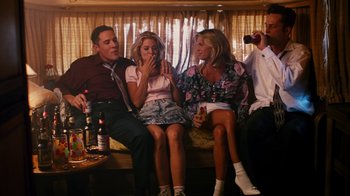 Movie still from “Swingers” (1996), directed by Doug Liman – A group of people sitting on a couch drinking and smoking; Medium shot, Low angle