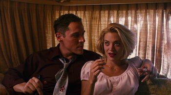 Movie still from “Swingers” (1996), directed by Doug Liman – A man and a woman sitting next to each other; Medium shot, Low angle