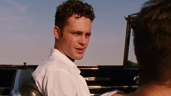 Movie still from “Swingers” (1996), directed by Doug Liman – A young man sitting in front of an old piano; Close Up shot, Low angle