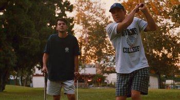 Movie still from “Swingers” (1996), directed by Doug Liman – Two men standing in the grass holding golf clubs; Medium shot, Low angle