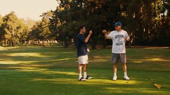 Movie still from “Swingers” (1996), directed by Doug Liman – Two men standing on a golf course talking to each other; Wide shot, Over the shoulder angle