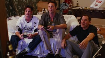 Movie still from “Swingers” (1996), directed by Doug Liman – A group of men sitting on a couch playing a video game; Medium shot, High angle