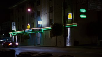 Movie still from “Swingers” (1996), directed by Doug Liman – A building with neon lights on the side of the building; Extreme Wide shot, Low angle