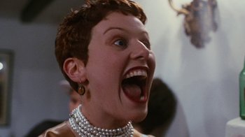 Movie still from “Swingers” (1996), directed by Doug Liman – A person wearing a pearl necklace; Close Up shot, Low angle