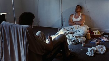 Movie still from “Swingers” (1996), directed by Doug Liman – Two men sitting on the floor in a room; Medium shot, Low angle