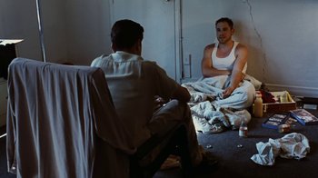 Movie still from “Swingers” (1996), directed by Doug Liman – Two men sitting on a bed talking to each other; Medium shot, High angle