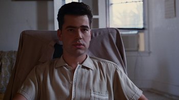 Movie still from “Swingers” (1996), directed by Doug Liman – A man sitting in a chair in front of a window; Close Up shot, Low angle