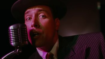 Movie still from “Swingers” (1996), directed by Doug Liman – A person wearing a suit and a hat; Close Up shot, Low angle