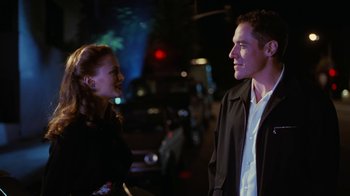 Movie still from “Swingers” (1996), directed by Doug Liman – A man and a woman standing next to each other on a street; Medium shot, Over the shoulder angle