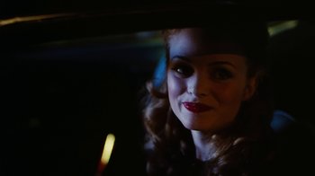Movie still from “Swingers” (1996), directed by Doug Liman – A woman with red lipstick sitting in a car at night; Close Up shot, Over the shoulder angle