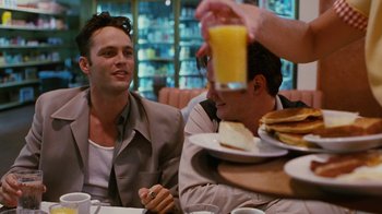 Movie still from “Swingers” (1996), directed by Doug Liman – Two men sitting at a table with plates of pancakes and a glass of orange juice in front of them; Medium shot, Over the shoulder angle