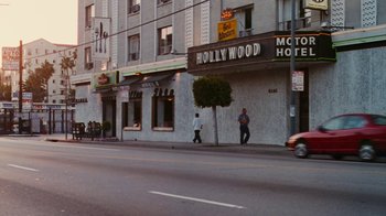 Movie still from “Swingers” (1996), directed by Doug Liman – Two people walking down the street in front of a movie theater; Extreme Wide shot, High angle