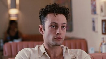 Movie still from “Swingers” (1996), directed by Doug Liman – A person wearing a white shirt; Close Up shot, Low angle