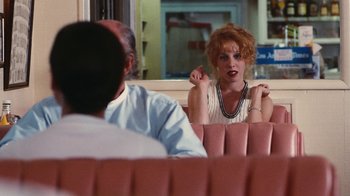 Movie still from “Swingers” (1996), directed by Doug Liman – A man and a woman sitting in a booth; Medium shot, Over the shoulder angle