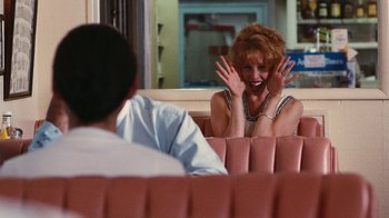 Movie still from “Swingers” (1996), directed by Doug Liman – A woman sitting next to a man on a bench; Medium shot, Over the shoulder angle