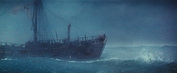 Movie still from “Swiss Family Robinson” (1960), directed by Ken Annakin – A boat in the middle of the ocean on a cloudy day; Extreme Wide shot, Low angle