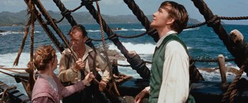 Movie still from “Swiss Family Robinson” (1960), directed by Ken Annakin – Two men standing on a boat in front of the ocean; Medium shot, High angle