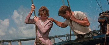 Movie still from “Swiss Family Robinson” (1960), directed by Ken Annakin – A man and a woman on a rope swing; Medium shot, Low angle