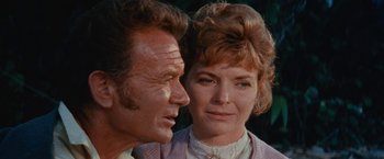 Movie still from “Swiss Family Robinson” (1960), directed by Ken Annakin – An older man standing next to an older woman; Close Up shot, Low angle