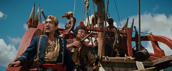 Movie still from “Swiss Family Robinson” (1960), directed by Ken Annakin – A group of people standing on top of a boat; Medium shot, Low angle
