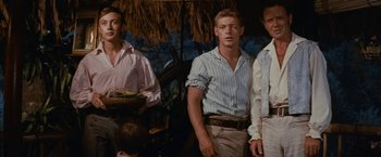 Movie still from “Swiss Family Robinson” (1960), directed by Ken Annakin – A group of men standing next to each other in a room; Medium shot, Over the shoulder angle
