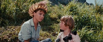 Movie still from “Swiss Family Robinson” (1960), directed by Ken Annakin – A woman and a boy in a field with binoculars; Close Up shot, Over the shoulder angle