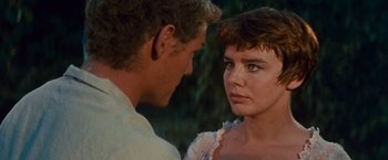Movie still from “Swiss Family Robinson” (1960), directed by Ken Annakin – A man and a woman looking at each other in front of trees; Close Up shot, Over the shoulder angle