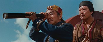 Movie still from “Swiss Family Robinson” (1960), directed by Ken Annakin – A man in a blue jacket holding a camera up to his face; Close Up shot, Low angle