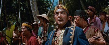 Movie still from “Swiss Family Robinson” (1960), directed by Ken Annakin – A group of men in traditional clothing standing next to each other; Close Up shot, Low angle