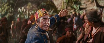 Movie still from “Swiss Family Robinson” (1960), directed by Ken Annakin – A man in a blue and red jacket and a red and yellow hat; Close Up shot, Low angle