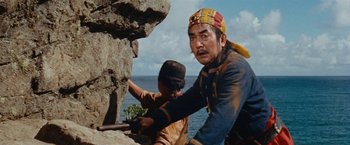 Movie still from “Swiss Family Robinson” (1960), directed by Ken Annakin – A man and a woman climbing a rock wall; Medium shot, Low angle
