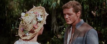 Movie still from “Swiss Family Robinson” (1960), directed by Ken Annakin – A man and a woman standing next to each other in front of a tree; Close Up shot, Over the shoulder angle