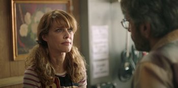 Movie still from “Sword of Trust” (2019), directed by Lynn Shelton – A woman looking at a man in the mirror; Close Up shot, Over the shoulder angle