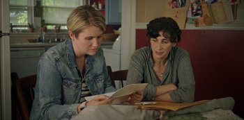 Movie still from “Sword of Trust” (2019), directed by Lynn Shelton – Two women sitting at a table looking at a piece of paper; Close Up shot, Over the shoulder angle